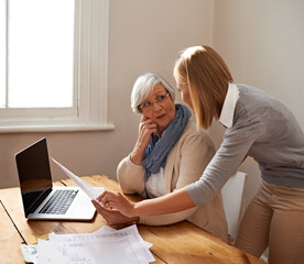 Fototapeta premium Senior woman, daughter and laptop with bills, finance and technology with advice and assistance. Help with online payment, budget with life insurance or conversation on tax paperwork in retirement