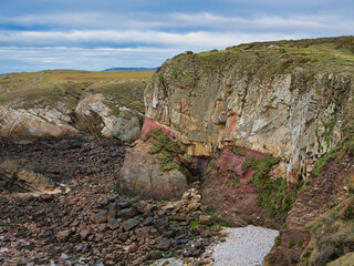 Colourful coastal cliffs on the Wales Coast Path. The rocks are of the New Harbour Group - Mica...