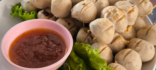 Grilled meatballs ready to eat with dipping sauce.