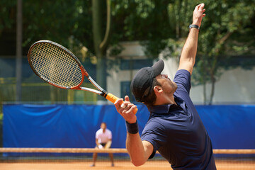 Fitness, sports and tennis with man serving on court to start match for competition or game from back. Exercise, health or training and man with racket at stadium or venue for beginning of tournament