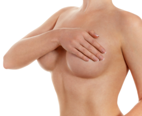 Woman covering breasts with hand on white background