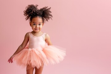Portrait of a little african girl in a pink ballerina tutu posing isolated on a pink pastel background