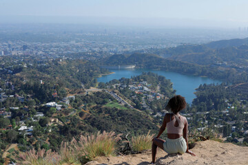 Dauntless Sexy African American Woman Sitting at the Edge of the Mountain of Hollywood Hiking, Los Angeles