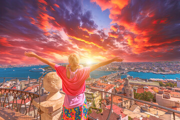 Fototapeta premium Woman embracing Istanbul cityscape at sunset, Back view of a woman with open arms enjoying the view of a vibrant city skyline at dusk on Galata Tower of Istanbul in Turkiye.