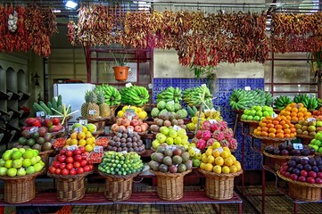A market stall adorned with a colorful array of diverse fruits, each exuding freshness and...