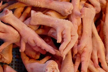 The chicken feet stall is immaculately clean, with neatly arranged rows of sanitized chicken feet....