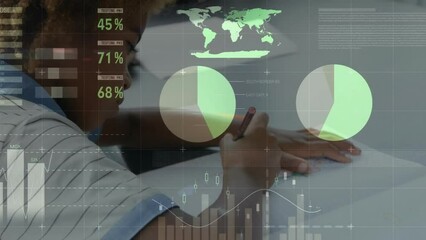 Animation of charts processing data over african american schoolboy writing in class - Powered by Adobe