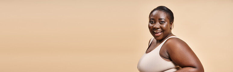 cheerful african american plus size woman embracing self-love and confidence, body positive banner