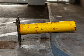 a fallen parking pillar in a parking garage