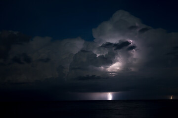 Thunderstorm with lightning the sky over the pierthe early morning.