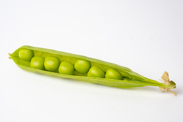 Ripe green peas on a white background.
