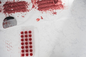 Kitchen work surface. Pink chocolate is poured into a plastic mold. Thickened chocolate spill.