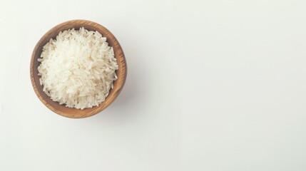 Fototapeta na wymiar Healthy food. Wooden bowl with parboiled rice on white background. Top view, copy space, high resolution product.