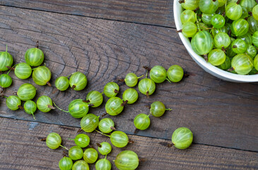 Ripe green gooseberries on a wooden table. Organic gooseberries.