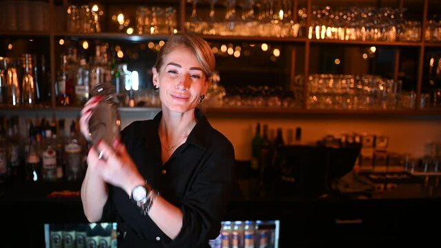 Woman bartender making cocktail in the bar