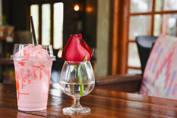 Glass with roses on the table