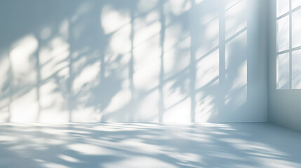 White table with window light and shadows in abstract and botanical shapes on a white wall. Background for product, cosmetics presentation.
