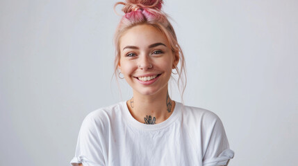 young woman with a cheerful smile, sporting a trendy top bun with pink hair, a nose ring, and visible tattoos, embodying a modern and joyful aesthetic.