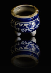 Old incense burner Ceramic isolated on black with reflection