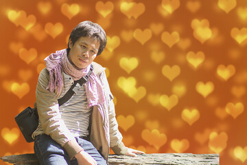 Valentine asian lonely man on bokeh cute little hearts love background