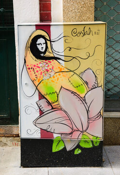 Porto, Portugal - April 26, 2015: Street art. Mona Lisa in pink flower on electric control box. Graffiti artist Costah uses a particular features of locations to create his cartoon style images.