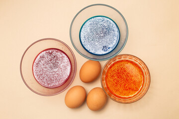 festive painted Easter eggs with colorful dyes on the table at home.