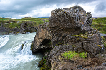 Icelandic landscape with a waterfall in the foreground, Iceland.