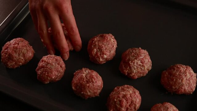  making raw meatballs close up
