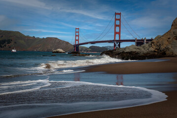 Panoramic view of the Golden Gate Bridge viewed from Baker beach on a mostly blue sky day copy space - 748090293