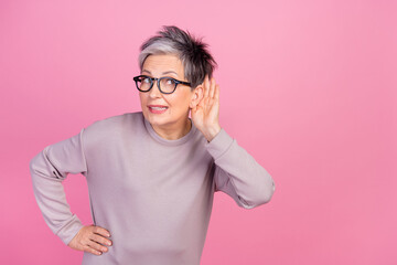 Closeup photo of pensioner grey haircut lady touch ear eavesdropping listen information empty space isolated on pink color background - obrazy, fototapety, plakaty