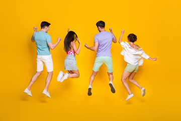 Fototapeta na wymiar Full length photo of best buddies jump rear view raise hands up isolated bright color background