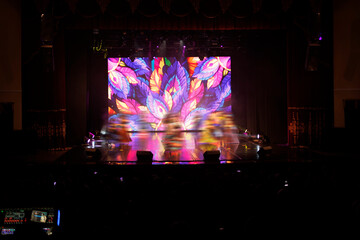An empty stage of the theater, lit by spotlights and smoke before the performance