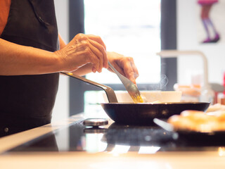 anonymous senior woman cooking