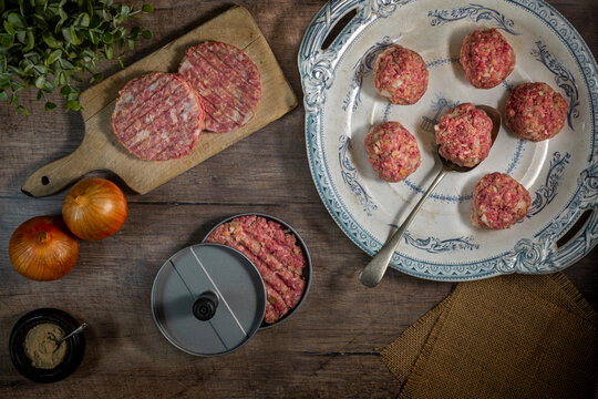cooking from scratch homemade beef burgers being formed in a burger press