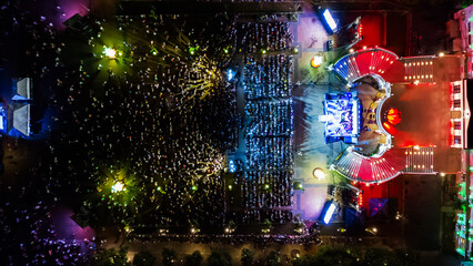 People at night open air concert aerial view