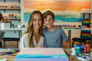 Smiling Young Woman and Boy Painting Together in Art Workshop with Bright Colors on Canvas