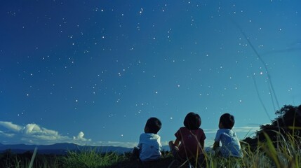 Children watch starry sky. Kids silhouettes against stars background. Child play on hill at...