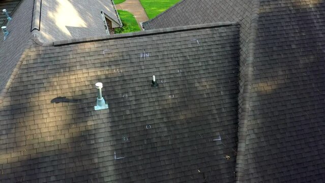 Roof with hail damage and markings from inspection