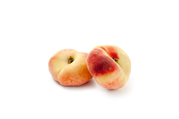 Two saturn peaches or flat peaches isolated on white background with clipping path..