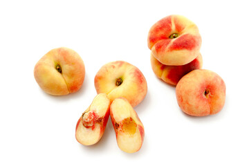 Half and several whole saturn peaches or flat peaches isolated on white background with clipping path..