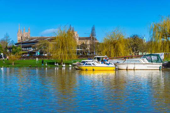 A view across the River Nene towards the distant cathedral in Peterborough, UK on a bright sunny day