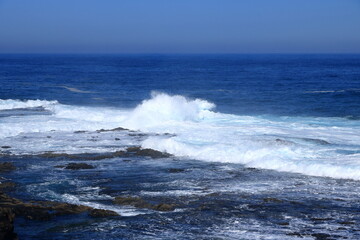 Stormy waves breaking on the stony beach in Fuerteventura in Jandia Natural Park