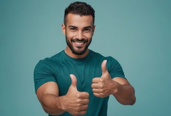 A smiling man in a teal shirt gives double thumbs up, radiating friendliness and confidence. - obrazy, fototapety, plakaty