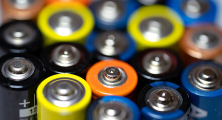 Batteries background. Composition with alkaline batteries. Cylindrical batteries set close-up