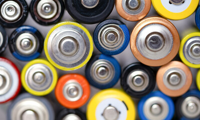 Batteries background. Composition with alkaline batteries. Cylindrical batteries set close-up