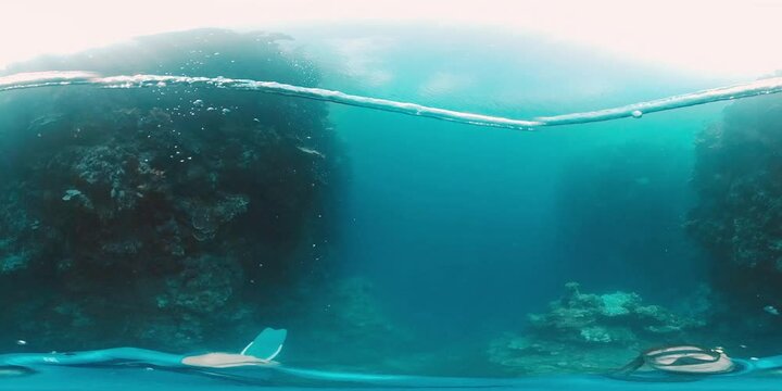 360VR underwater footage of the freediver having fun in the tropical sea in West Papua and making ring bubbles underwater. Area of the island of Misool, Raja Ampat, Indonesia