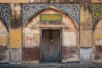 A wooden door at historic landmark Masjid Wazir Khan, a 17th-century Mughal mosque located in the city of Lahore, Punjab, Pakistan. - 748120659