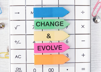 The text CHANGE EVOLVE written on arrow-shaped stickers