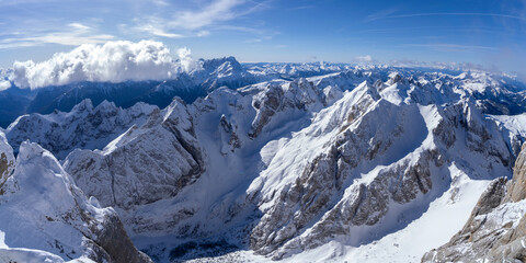 Fototapeta na wymiar Panoramic View of Majestic Snow-Covered Mountains under Clear Sky