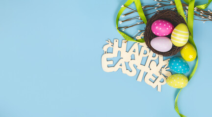 greeting card with text happy easter. multicolored easter eggs on blue background